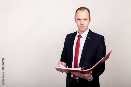 Busniessman posing with clipboard isolated on white background photo