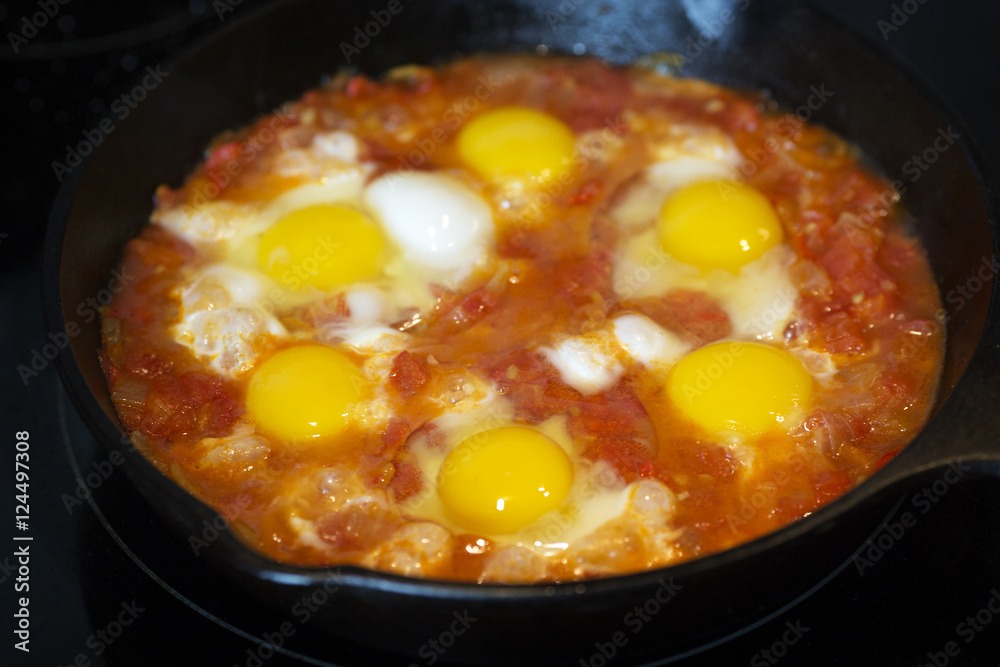 Shakshouka - fried eggs with tomatoes, Israeli national dish. Shakshouka - fried eggs with tomatoes, Israeli national dish.