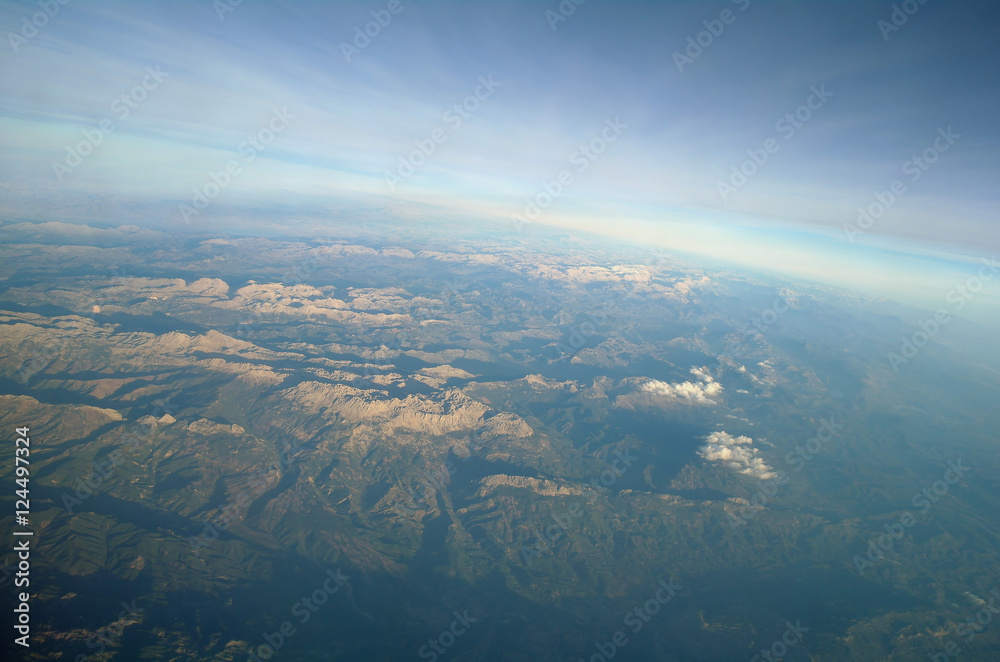 Aerial view above clouds and landscape