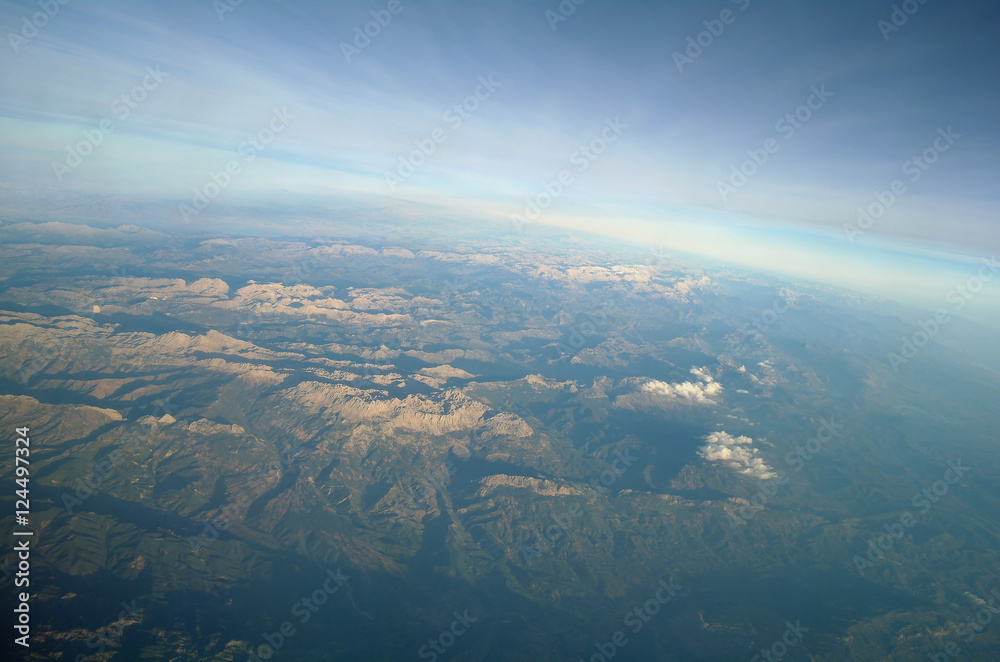 Aerial view above clouds and landscape Aerial view above clouds and landscape