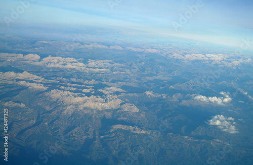 Aerial view above clouds and landscape