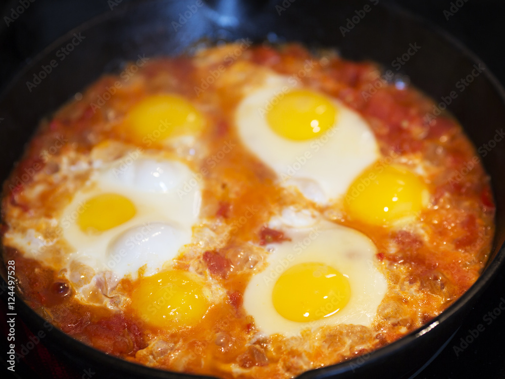 Shakshouka - fried eggs with tomatoes, Israeli national dish. Shakshouka - fried eggs with tomatoes, Israeli national dish.