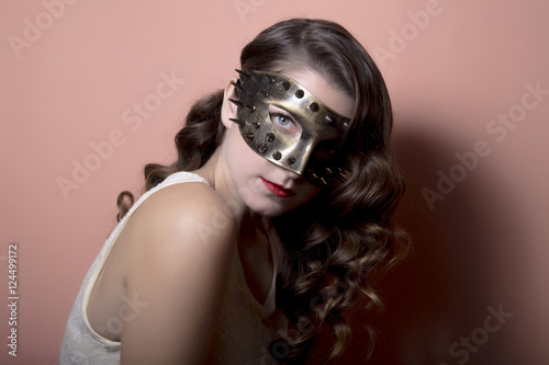 Beautiful Woman in a Carnival Mask. Halloween holiday concept.