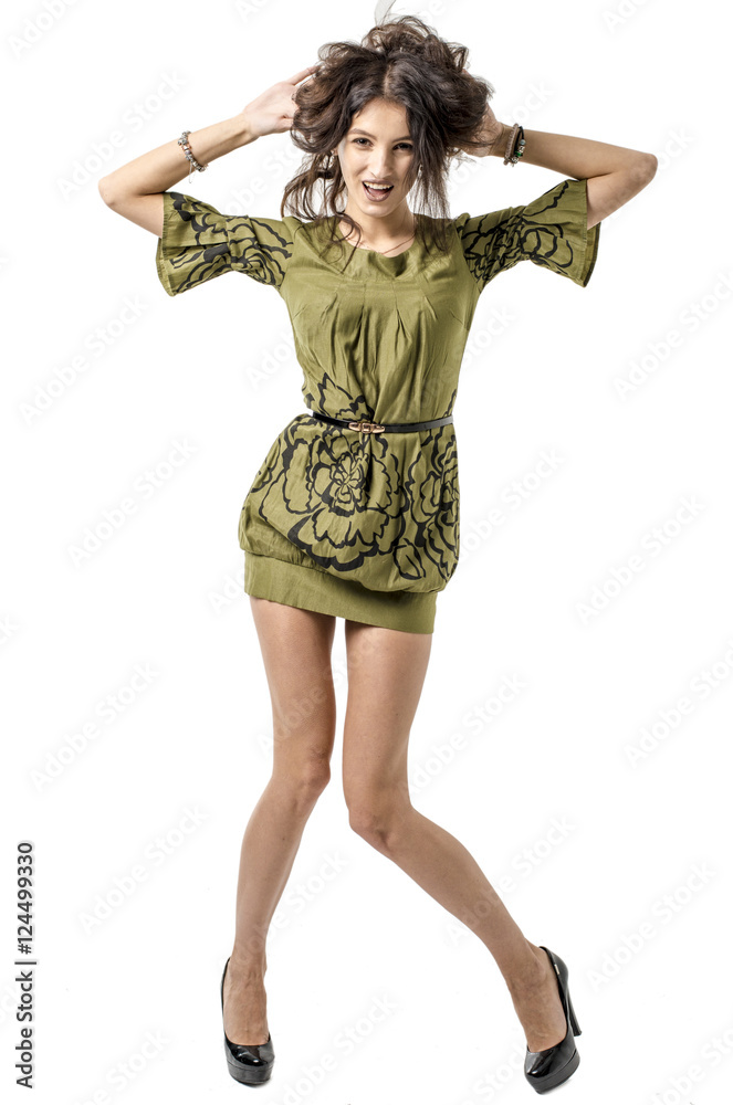 Fototapeta premium Slender young cheerful girl brown hair dances with a bouquet of colorful flowers on her head