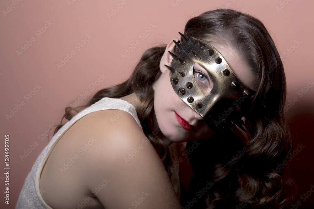 Beautiful Woman in a Carnival Mask. Halloween holiday concept.