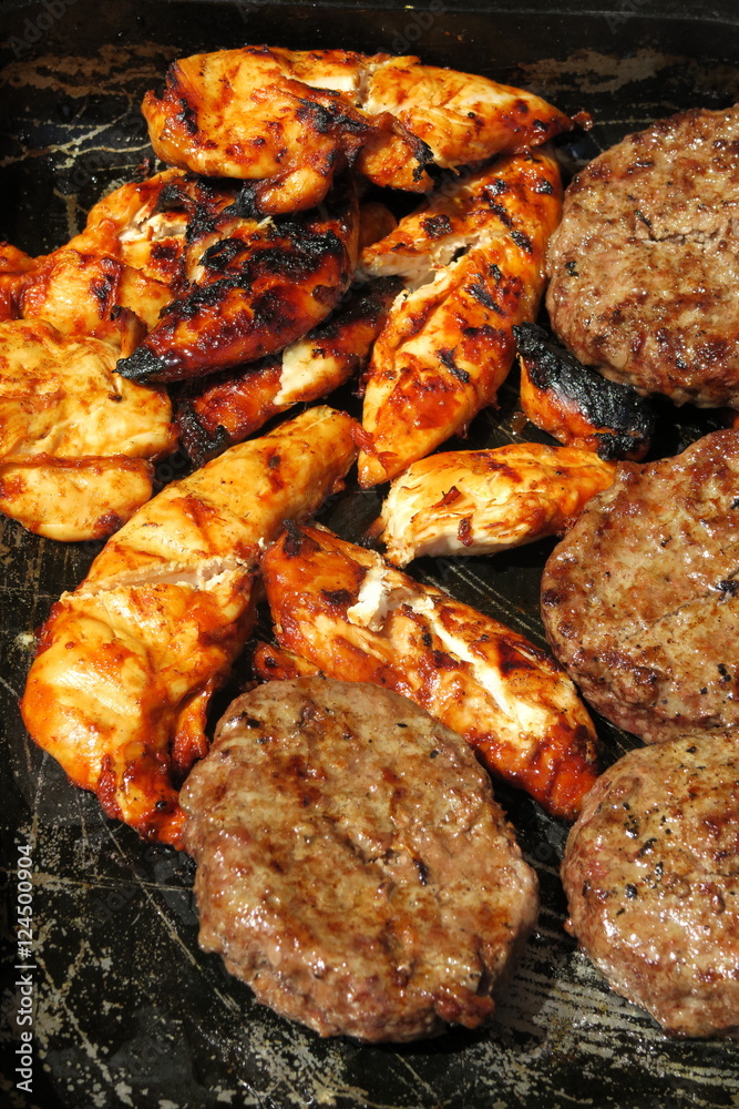 The concept of sunny summer days with Golden chicken & sizzling burgers on a tray ready to eat