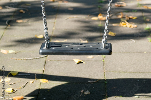 Plastic swing in a playground photo