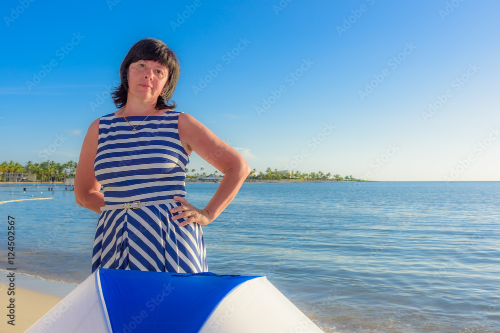 brunette woman with a beach umbrella