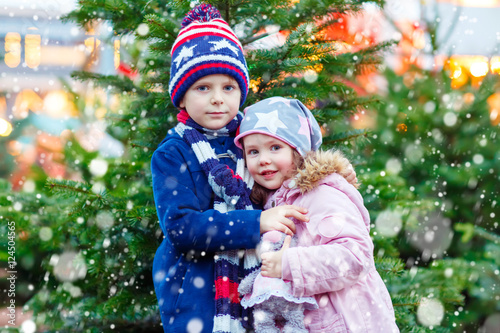 Two little kids hugging on Christmas market