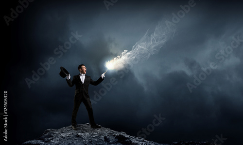 Businessman demonstrating magic . Mixed media © Sergey Nivens