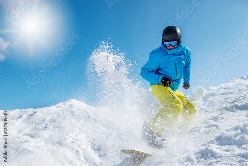 Active young man snowboarding