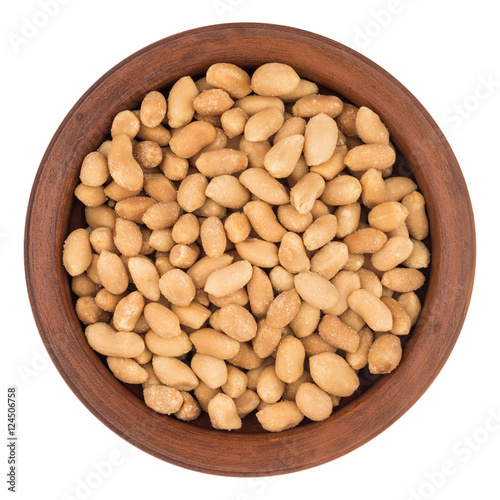 Salted peanuts in a brown plate. Isolated on white background.