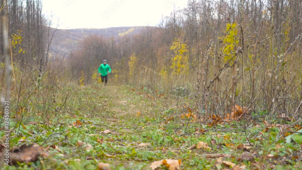 Sport Man jogging cross country running. Training and exercising outdoors when cross country running in inspirational autumn landscape. Sports Motivation. Sport Man jogging cross country running. Training and exercising outdoors when cross country running in inspirational autumn landscape. Sports Motivation.