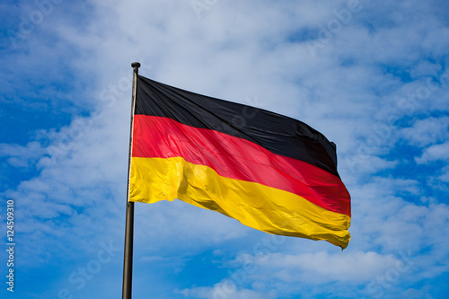 German Flag at blue cloudy sky