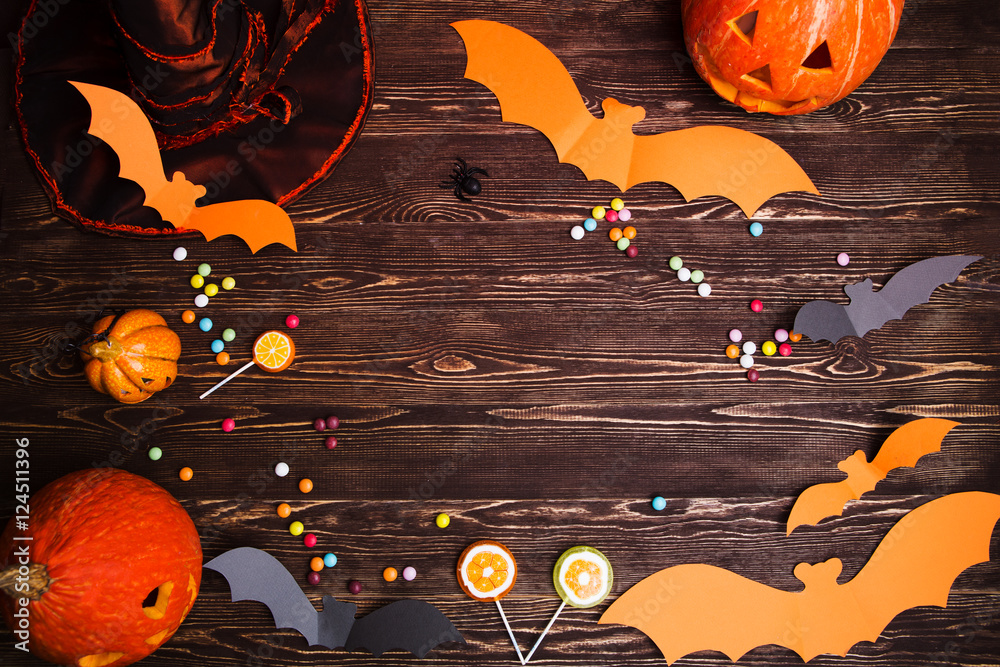 Naklejka premium Halloween holiday background with pumpkin and bats.