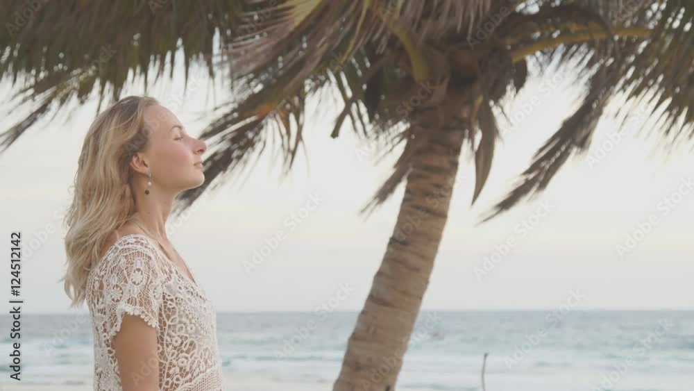 beautiful woman looking at the sea at sunset beautiful woman looking at the sea at sunset
