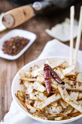 Stir fried cabbage in wok with pepper