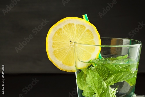 Refreshing mint and lemon. Homemade lemonade with fresh lemon and mint. Mint julep in glass on the wooden background. 