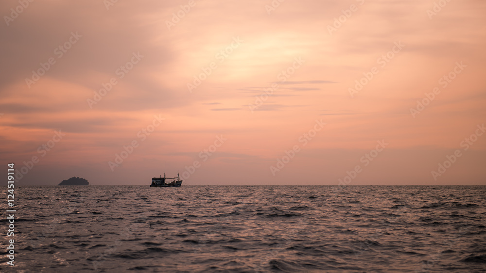 little boat in the sea with sunset