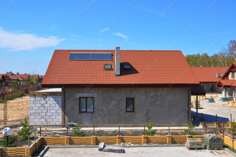 Solar Water Heater, Solar Panels and Skylights, Beautiful New Contemporary House with Solar water panel heating. Roofing Construction. House Construction. Solar panel for hot water system.