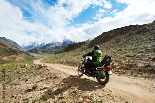 Motorbike tourism. Traveller at motorcycle in mountains