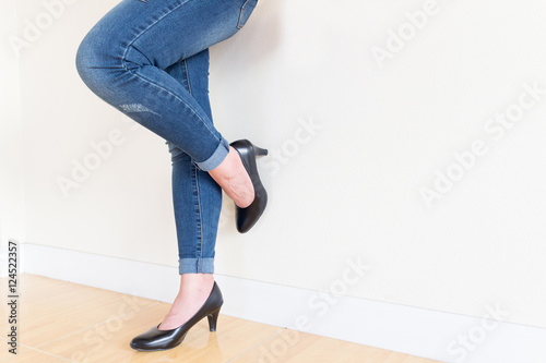 Women's jeans, black high-heeled shoes. White background