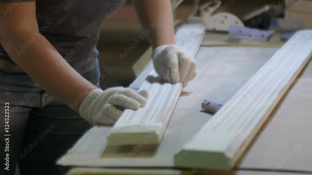 Female carpenter polishing board on the furniture factory Female carpenter polishing board on the furniture factory