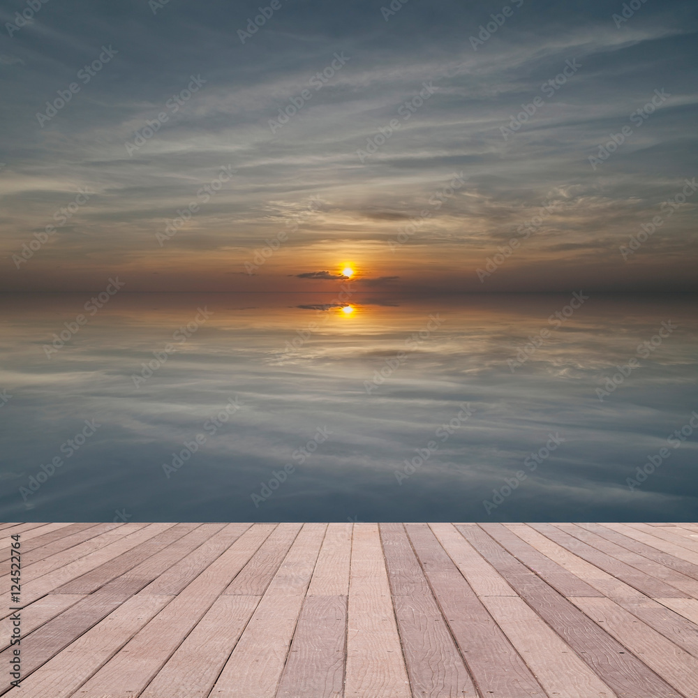 perspective wood plank floor on sunset sky sea with reflex backg