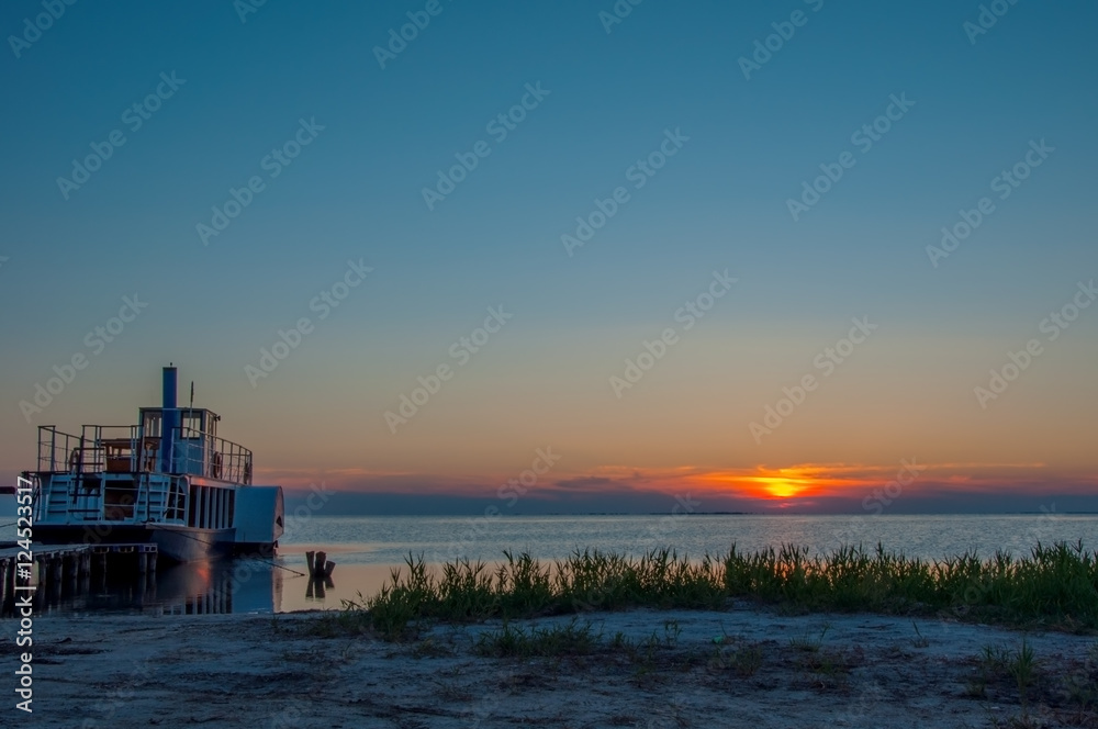 Paddle steamer on the river at sunset Paddle steamer on the river at sunset
