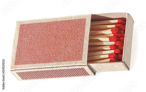 Matches in a matchbox. Isolated on white background. Soft focus.