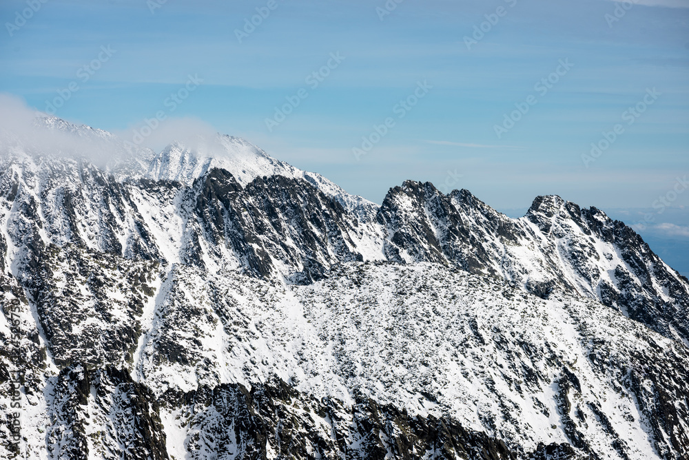 mountain tops in winter covered in snow mountain tops in winter covered in snow