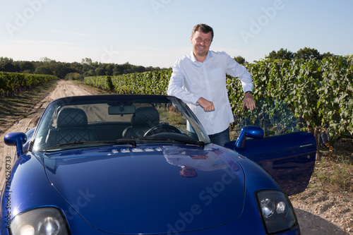 Businessman, winegrower, in his convertible blue car © OceanProd