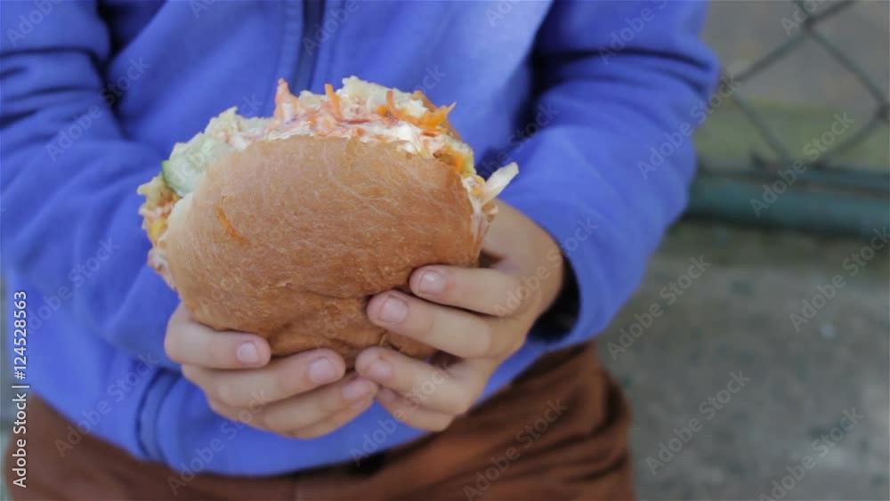 Hamburger in hands/boy holding a big burger Hamburger in hands/boy holding a big burger