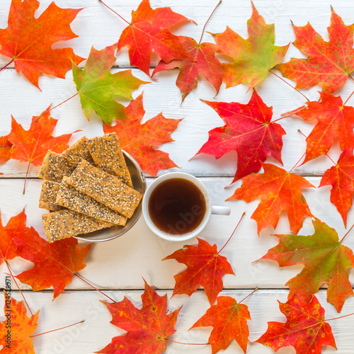 Cup of coffee and flat seeds cookies on white wooden background photo