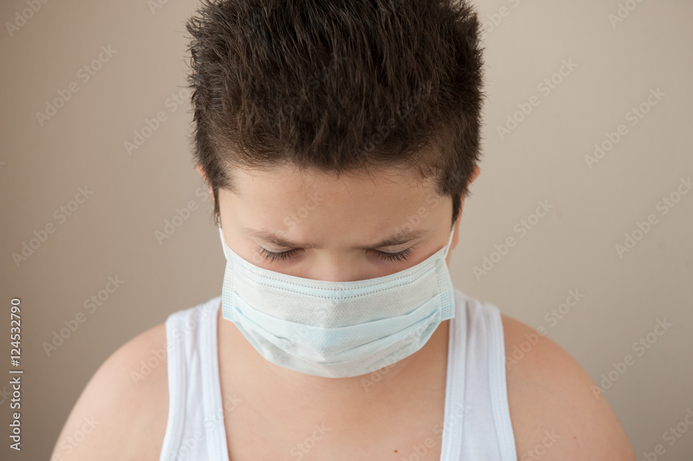 little boy wearing surgical mask