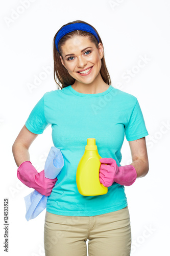 Smiling hosewife holding bottle of cleaner. photo