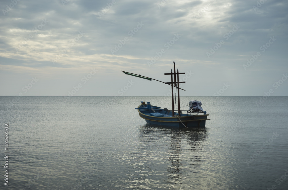 traditional fishing boat laying on the sea.cloudy sky.filtered image.selective focus traditional fishing boat laying on the sea.cloudy sky.filtered image.selective focus