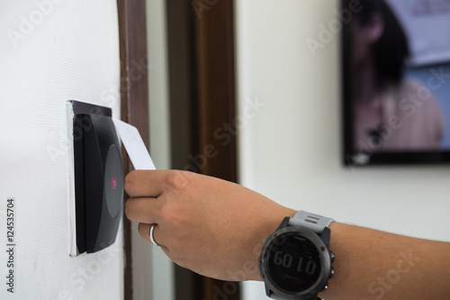 Door access control with a hand inserting key card to lock and u