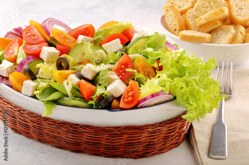 Greek salad with feta cheese black olives and bruscheta photo