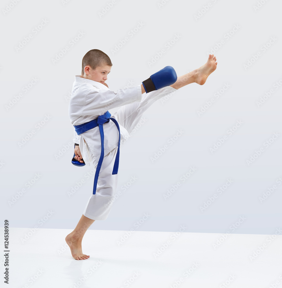 High kick forward karateka is beating in karategi High kick forward karateka is beating in karategi