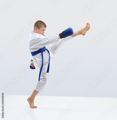High kick forward karateka is beating in karategi