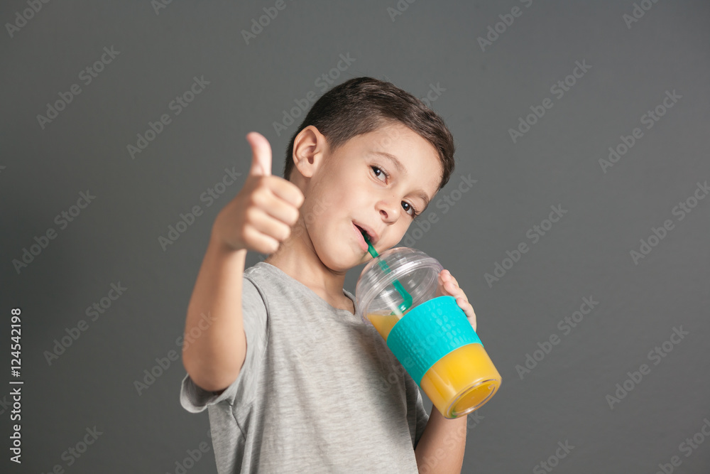 Little funny boy drinking a fresh juice through a straw Little funny boy drinking a fresh juice through a straw