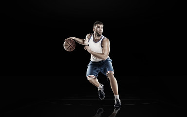 Basketball player in action isolated on black background