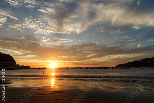 Sunset on a sea beach with fantastic sky clouds. Twilight reflection . San Juan del sur, Nicaragua