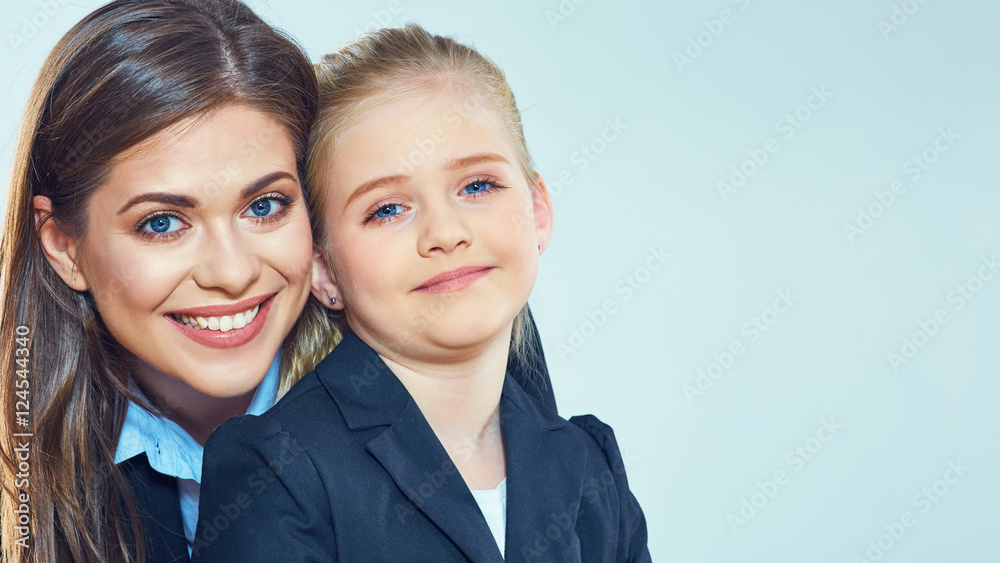 Smiling mother with daughter in business suits. Smiling mother with daughter in business suits.