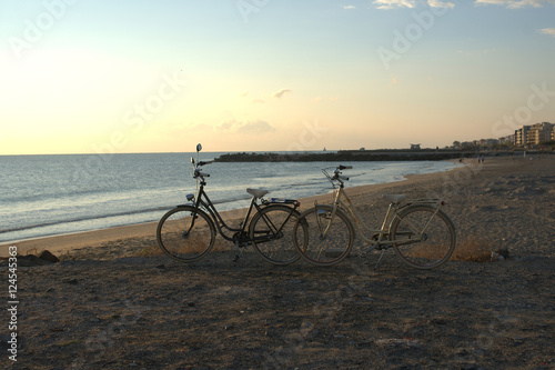  Two bikes on the beach at dawn © Olga Tkacheva