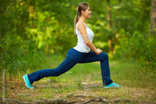 Smiling Woman doing stretching exercise