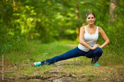 Smiling Woman doing stretching exercise