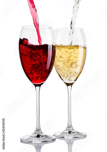 Glass of red and white wine pouring from bottle