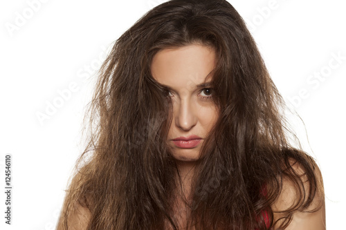 portrait of nervous young woman with tousled hair